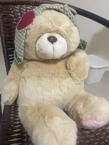 Soft beige teddy bear with bow — gently used