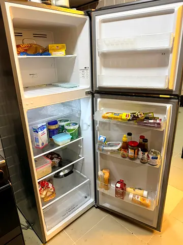 Used double-door refrigerator with freezer on top - good working condition