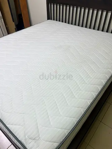 IKEA IDANÄS bed with a dark wood frame