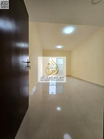 Two-bedroom apartment with a living room, private parking, and built-in wardrobes for annual rent in Ajman.
