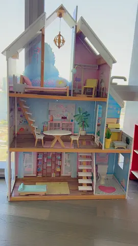 A beautiful wooden doll house for sale with all extra bought toys shown in the pictures