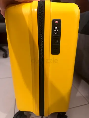 Bright yellow hard-shell carry-on suitcase with TSA lock