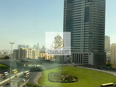 Two bedrooms and a living room with a large hallway, panoramic windows throughout, in Bushgara, Al Wahda Street, first exit directly to Dubai, built-i