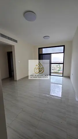 Al-Aliya area, on the main road, very close to Sheikh Mohammed Bin Zayed Road - First occupancy - Two bedrooms, living room, 3 bathrooms with balcony