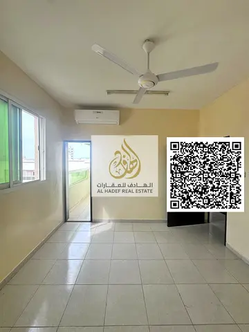 Two-bedroom apartment with a living room in Rawda 1, near Al Hamidiya Police Station. Features a balcony, two bathrooms, and split air conditioning. R