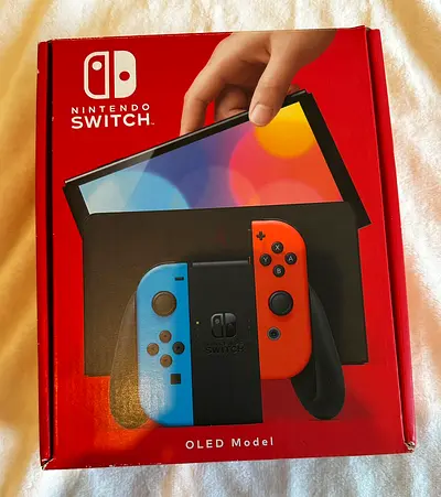 Nintendo Switch OLED console (Neon Joy‑Con) in original box - never used, excellent condition