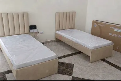 Pair of beige single beds with headboards — good condition