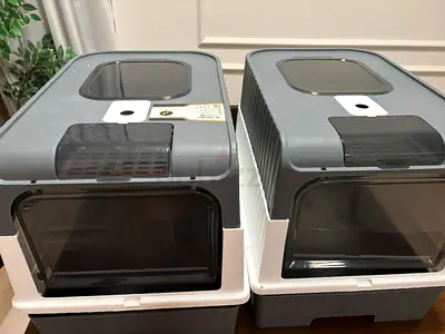 Set of Two Enclosed Cat Litter Boxes with Flap Doors (AED 100 for each, total AED 200 for both)