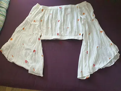 White off-shoulder crop top with embroidered floral detail, and flared sleeves, size 14