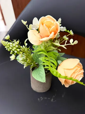 Small artificial rose arrangement in ceramic vase