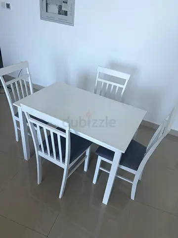 White 4-Seater Dining Table with Cushioned Chairs