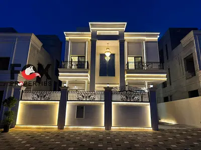 Luxury classic villa for sale in Al Helio 1, Ajman, featuring 6 master bedrooms, full stone façade,