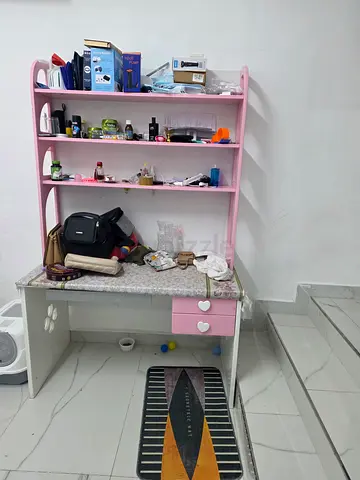 Pink childrens study desk with shelves