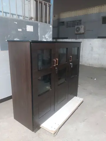 Compact dark wood cabinet with glass doors - good condition