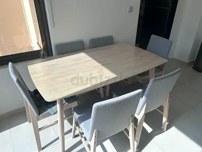 Light wood dining table with 6 grey upholstered chairs - good condition