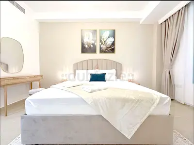 Queen upholstered bed with headboard and matching bedside tables