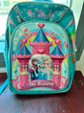 Kids Frozen backpack — light blue school bag with castle print