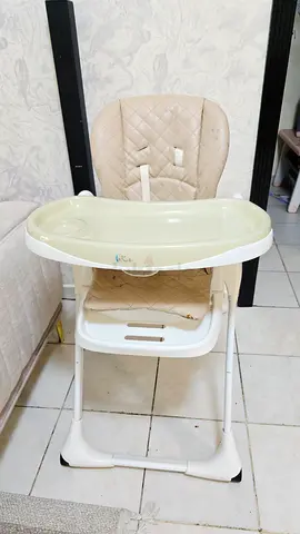 Used beige baby high chair with detachable tray adjustble height.