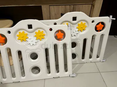 Used white plastic baby play yard / safety gate panels with activity gears. Two full sets available.