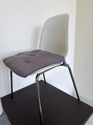 White modern chair with grey seat cushion