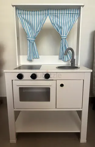 Ikea kitchen set with pots, pans, pizza, hamburger, vegetables cutting, and cinnamon buns