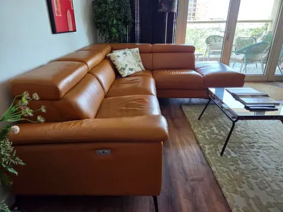 L-shaped sectional sofa in tan — excellent condition with electric reclining seat