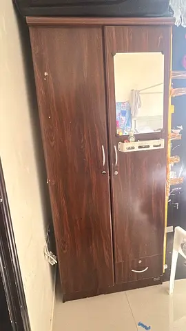 Urgently selling dark wood 2-door wardrobes with mirror - 50 AED on 10 june.