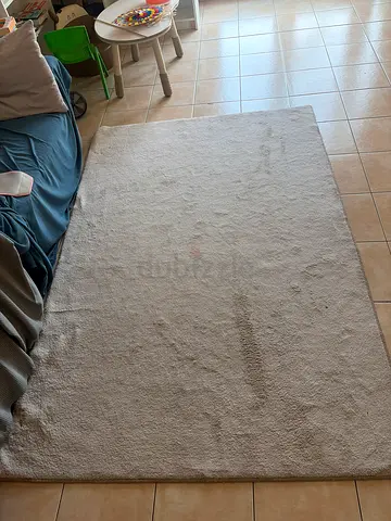 Light beige solid-color area rug - used, good condition