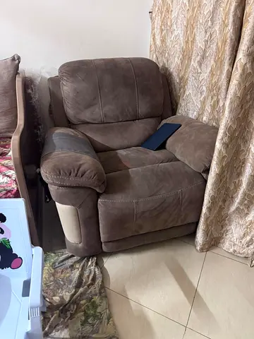 Comfortable brown single recliner armchair in good condition.Fabric