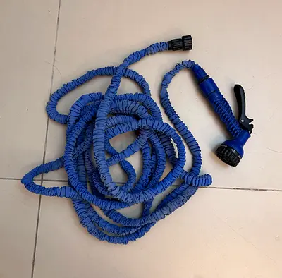 Expandable garden hose with spray nozzle - used