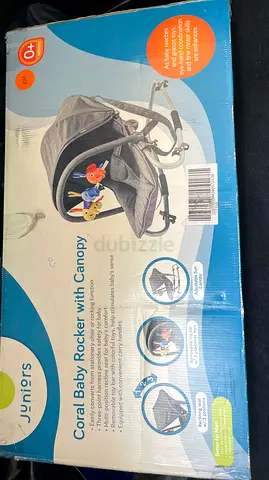 Juniors Coral Baby Rocker with Canopy and Toy Bar - Light Grey never used. It’s a sealed piece,,