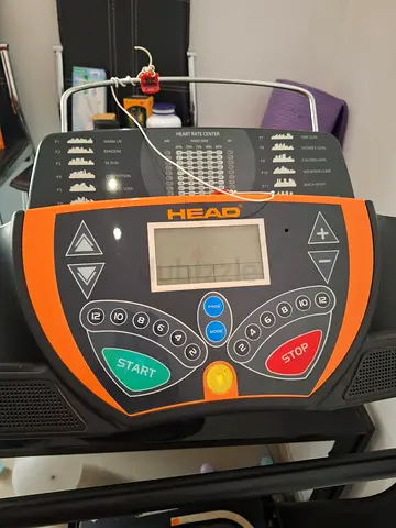 This is a Head branded treadmill console with an orange and black