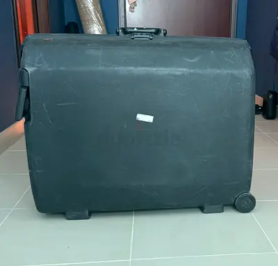 Large black hard-shell suitcase with wheels — used