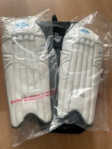 Pair of new cricket wicket keeping leg pads - unused, still in plastic