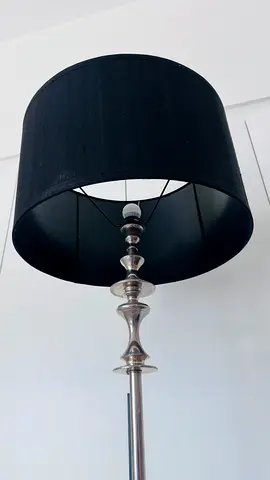 Tall metal floor lamp with black drum shade