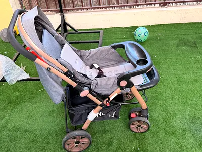 Lightly used grey baby stroller with reclining seat and tray