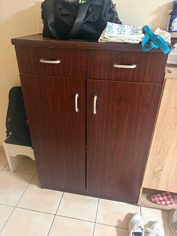 Compact wooden storage cabinet with two doors and drawer
