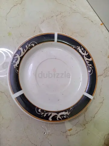 Classic round decorative saucer with navy and gold rim
