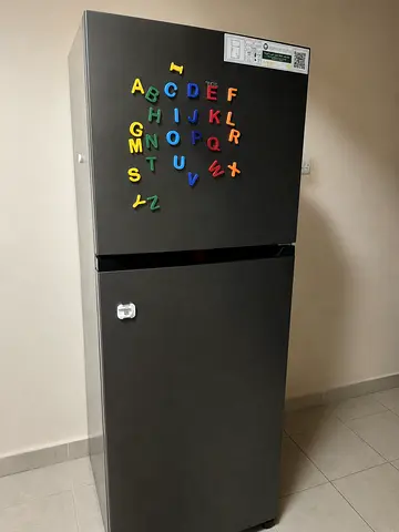 Medium-sized top-freezer refrigerator in good working condition