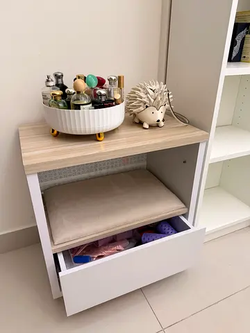 Small white vanity storage unit with pull-out drawer and cushioned stool
