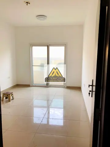 annual rent in Al Jurf 2 – Ajman. The apartment features 2 master bedrooms, built-in wardrobes, a balcony, and a practical layout in a clean family-on
