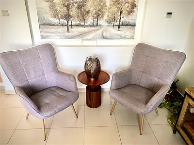 Pair of modern grey upholstered accent chairs with wooden legs