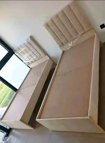 Pair of single wooden bed frames with headboards - beige