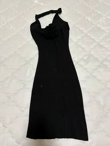 Black sleeveless knit dress with halter neck and flower detail -