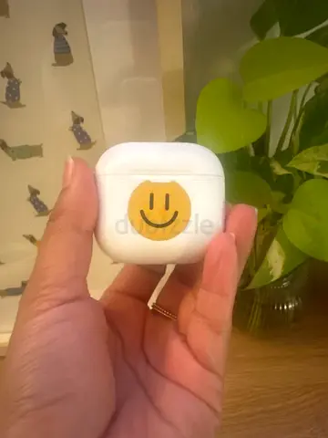 Wireless earbud charging case (AirPods-style) with smile sticker