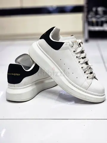 Alexander McQueen oversized sneakers in white leather with a black heel counter.