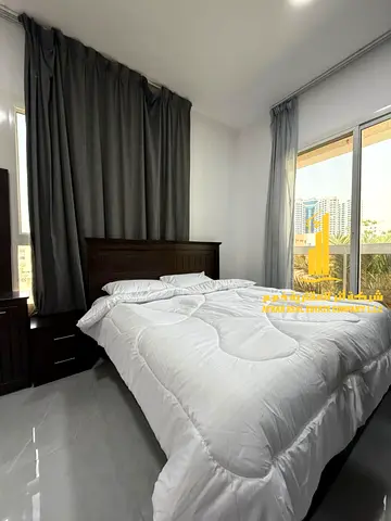 For monthly rent in Ajman, two-bedroom apartment with a balcony open view, fully furnished new with elegant furniture and a fully equipped kitchen