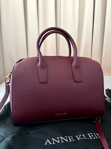 Maroon leather crossbody handbag with top handles