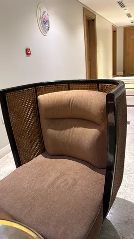 Curved Rattan-Back Accent Chair with Brown Upholstery