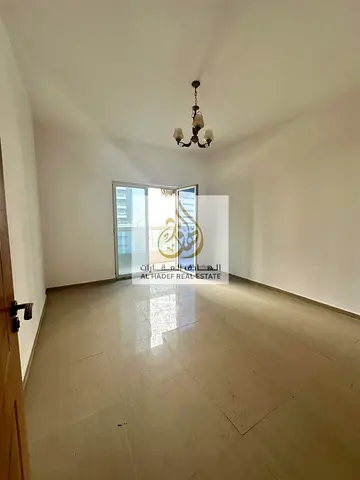 Two-bedroom apartment with a living room for annual rent in Al Nuaimiya 3, directly on Sheikh Khalifa Street.